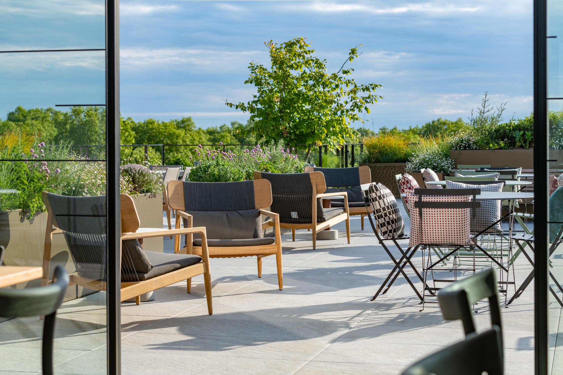 An image of a roof top terrace design & build by Bowles & Wyer, featuring outdoor seating and planting