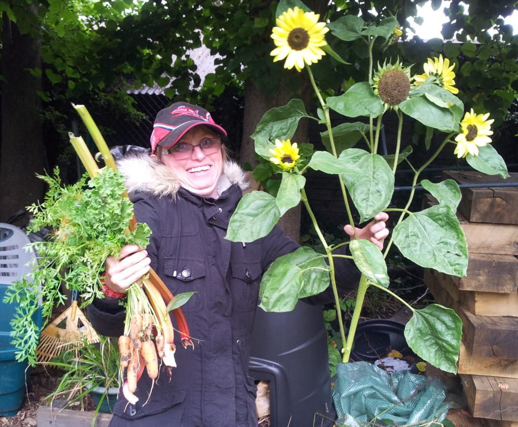 One of our gardeners with some of the things she's grown this year