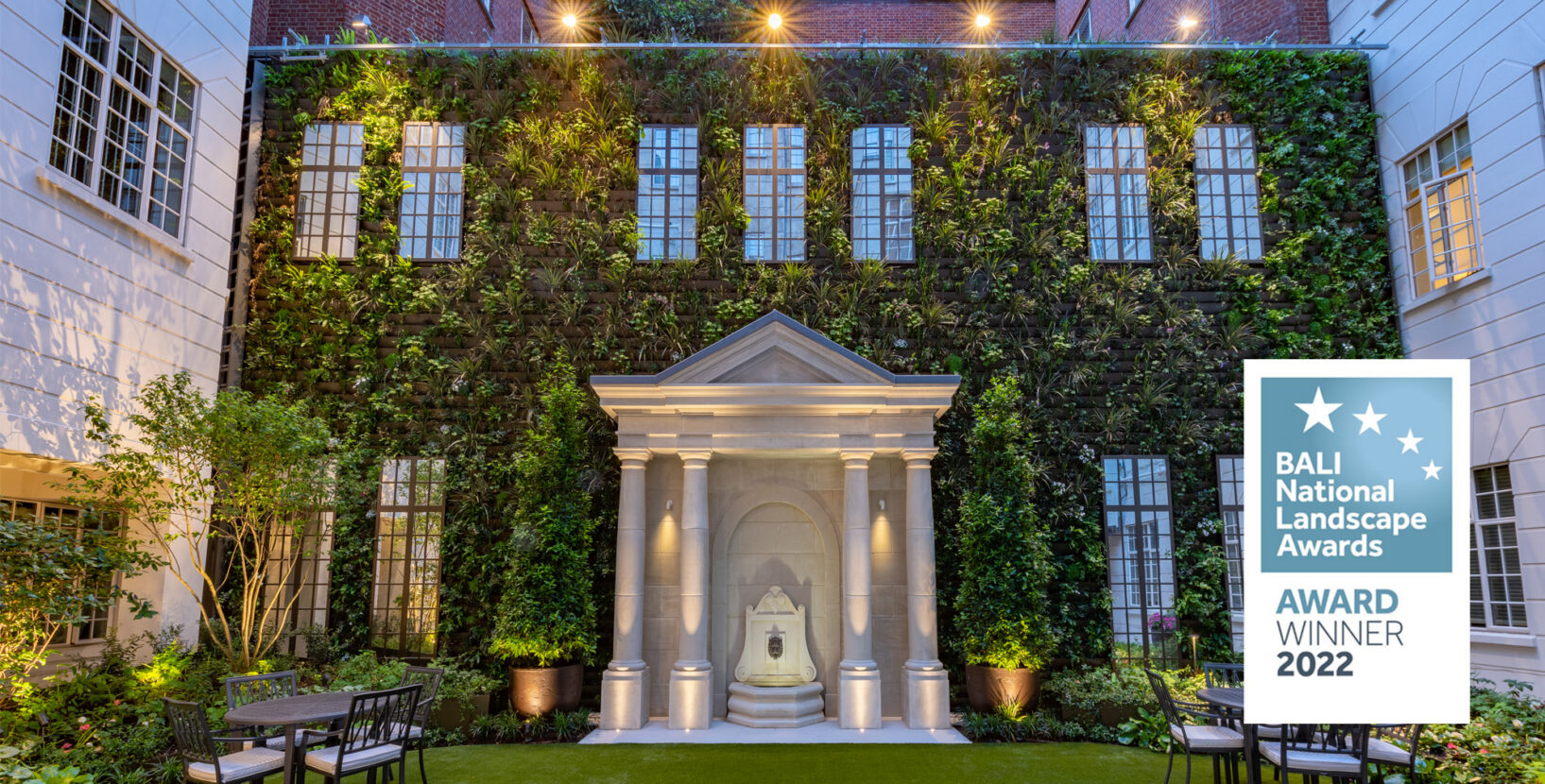 London courtyard garden, built by Bowles & Wyer, designed by LA London Architects. Outdoor lighting, large plant pots, water fountain feature, living wall