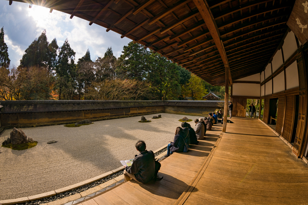 people sat beside the gravel/rock garden, sitting and reflecting